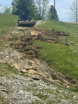 Removing dirt to make driveway